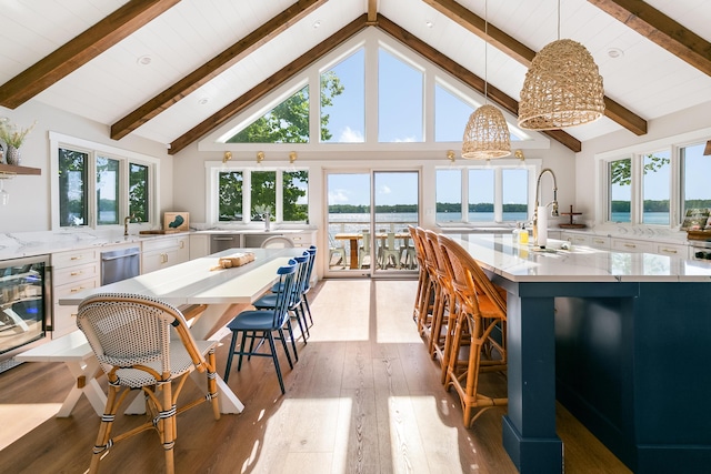 67881 Edgewater Beach Rd, White Pigeon, MI 49099 - kitchen with wine cooler, dishwasher, white cabinets, light wood finished floors, and high vaulted ceiling