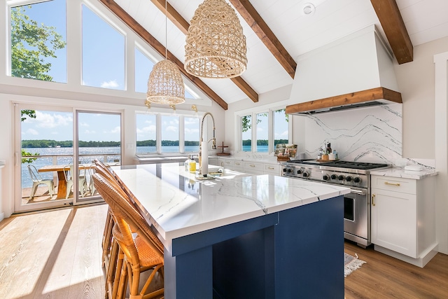 67881 Edgewater Beach Rd, White Pigeon, MI 49099 - kitchen featuring high end stainless steel range, beam ceiling, premium range hood, light wood finished floors, and white cabinetry