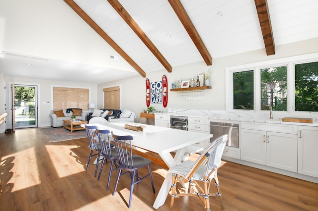 67881 Edgewater Beach Rd, White Pigeon, MI 49099 - dining area with wine cooler, light wood-style flooring, high vaulted ceiling, and wood ceiling with exposed beams