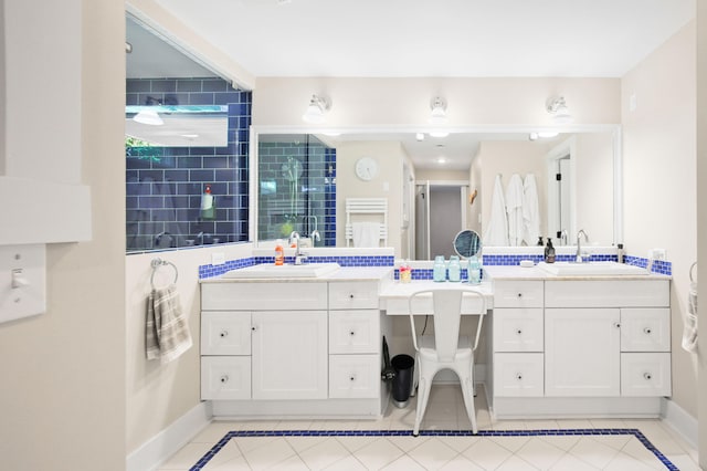 67881 Edgewater Beach Rd, White Pigeon, MI 49099 - bathroom featuring inlaid floor details, baseboards, two vanities, and tile patterned floors