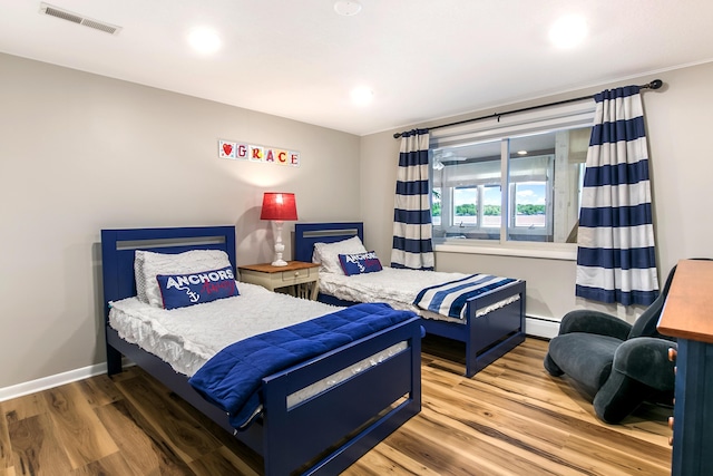 67881 Edgewater Beach Rd, White Pigeon, MI 49099 - bedroom featuring wood finished floors, recessed lighting, a baseboard heating unit, and baseboards
