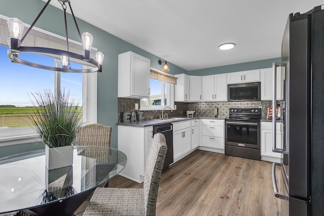 4380 W Chicago Rd, Jonesville, MI 49250 - kitchen featuring electric stove, freestanding refrigerator, a chandelier, dishwasher, and tasteful backsplash