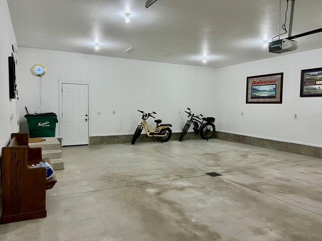 2985 Middle Lake Rd, Twin Lake, MI 49457 - garage with a garage door opener and baseboards