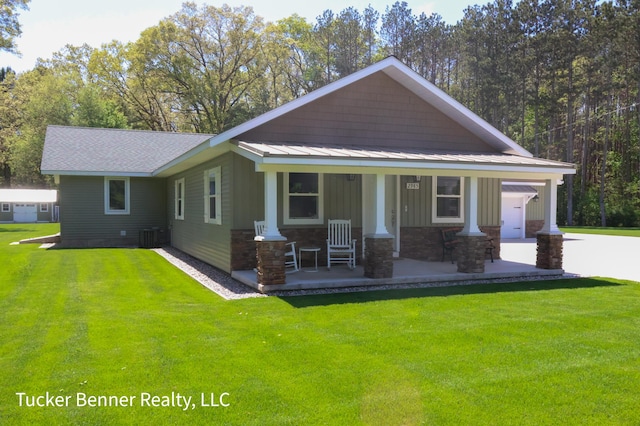 2985 Middle Lake Rd, Twin Lake, MI 49457 - craftsman-style home featuring a porch, a front lawn, driveway, board and batten siding, and stone siding