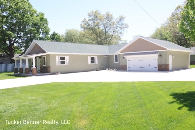2985 Middle Lake Rd, Twin Lake, MI 49457 - view of front facade with a front yard, a garage, covered porch, and concrete driveway