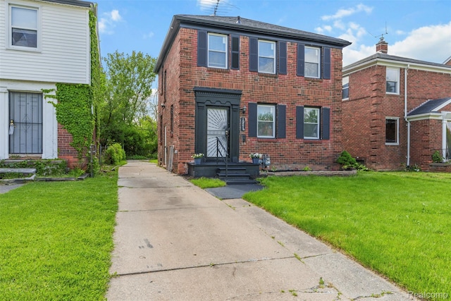 10576 Somerset Ave, Detroit, MI 48224 - view of front of house featuring brick siding, a front yard, a chimney, and driveway