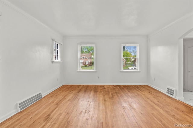 10576 Somerset Ave, Detroit, MI 48224 - spare room with light wood finished floors, crown molding, arched walkways, and baseboards