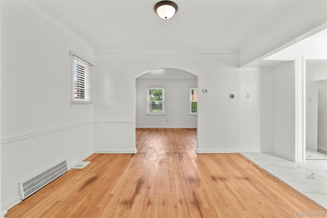 10576 Somerset Ave, Detroit, MI 48224 - unfurnished room with arched walkways, light wood-style floors, and baseboards