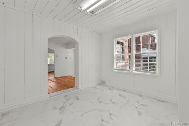 10576 Somerset Ave, Detroit, MI 48224 - unfurnished room featuring arched walkways, baseboards, and marble look tile flooring