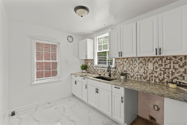 10576 Somerset Ave, Detroit, MI 48224 - kitchen featuring a sink, stone countertops, light marble finish flooring, and white cabinets
