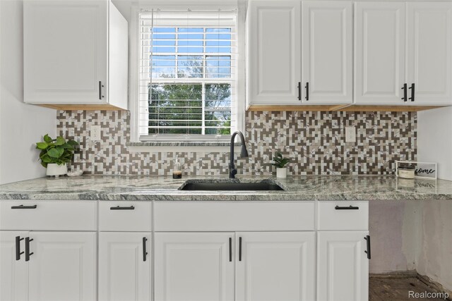 10576 Somerset Ave, Detroit, MI 48224 - kitchen with a sink, white cabinetry, and backsplash