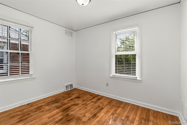 10576 Somerset Ave, Detroit, MI 48224 - unfurnished room featuring healthy amount of natural light, wood-type flooring, and baseboards