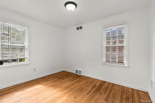 10576 Somerset Ave, Detroit, MI 48224 - spare room with light wood-style flooring, ornamental molding, and baseboards