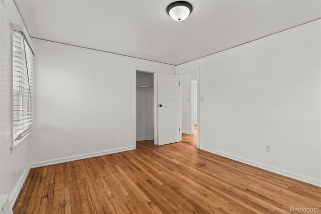 10576 Somerset Ave, Detroit, MI 48224 - unfurnished bedroom with wood finished floors, baseboards, and a closet