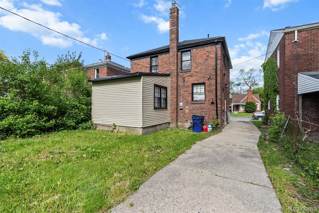 10576 Somerset Ave, Detroit, MI 48224 - rear view of property featuring brick siding and a chimney