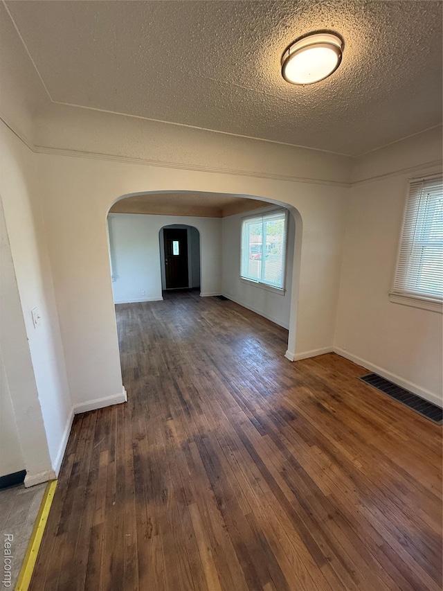 1226 E Princeton Ave, Flint, MI 48505 - unfurnished room with arched walkways, hardwood / wood-style flooring, and a textured ceiling