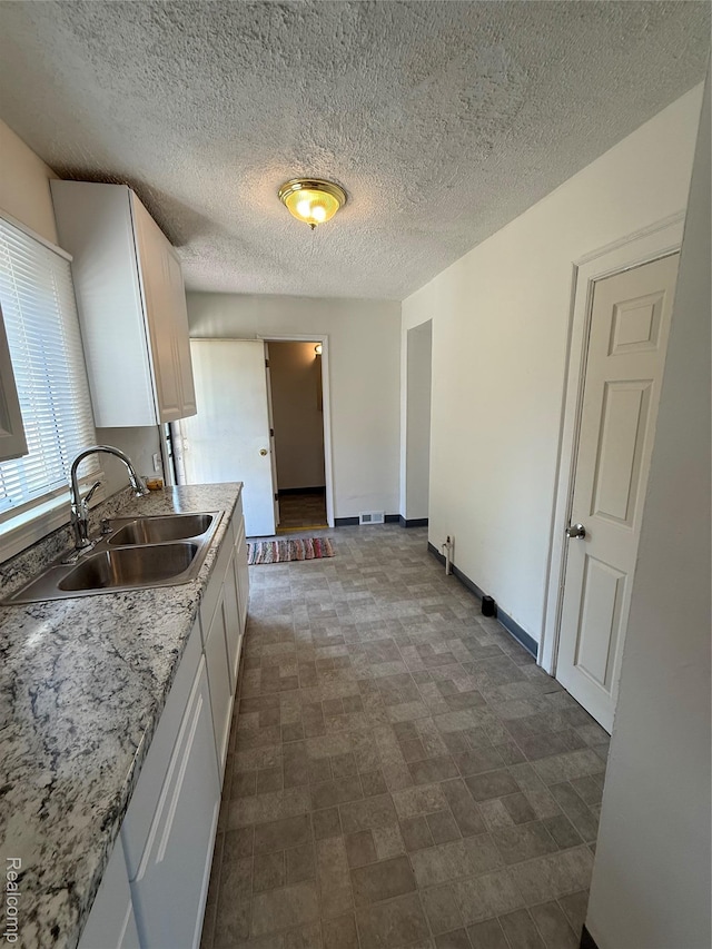 1226 E Princeton Ave, Flint, MI 48505 - kitchen featuring white cabinetry and light countertops
