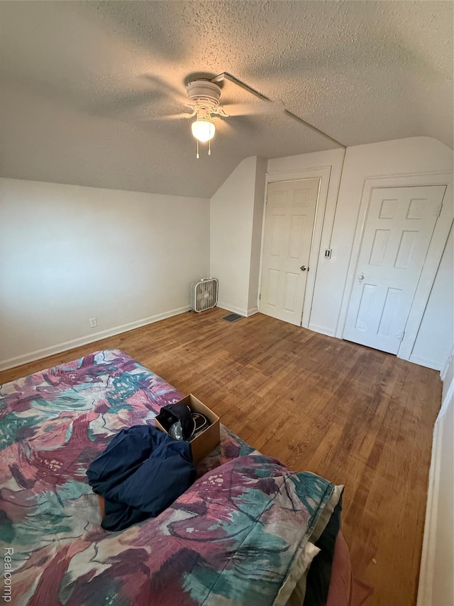 1226 E Princeton Ave, Flint, MI 48505 - bedroom featuring vaulted ceiling, a textured ceiling, wood finished floors, and ceiling fan