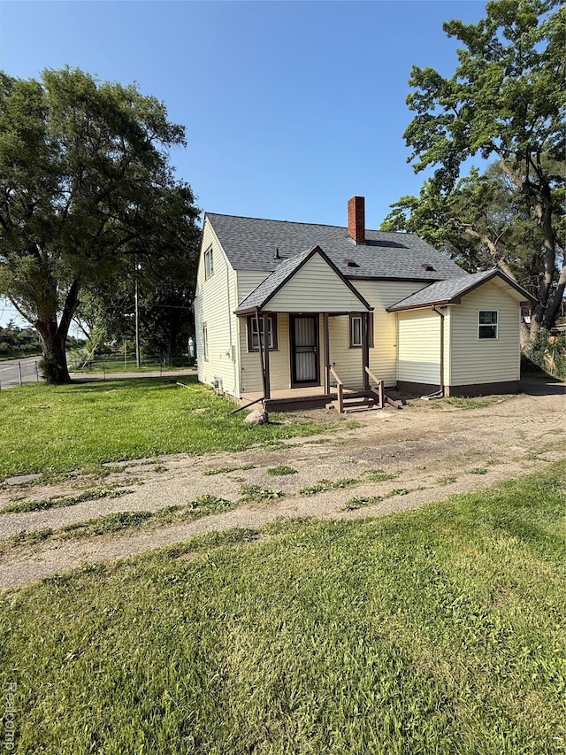 1226 E Princeton Ave, Flint, MI 48505 - view of front facade with a chimney, a front lawn, and roof with shingles