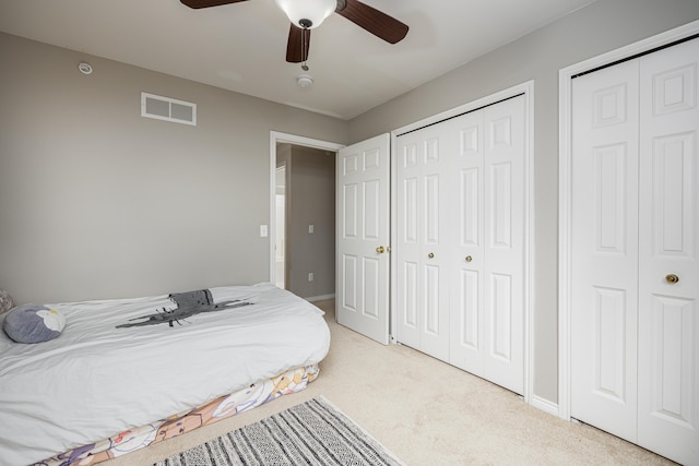 3039 Barclay Way, Ann Arbor, MI 48105 - bedroom featuring two closets, light carpet, a ceiling fan, and baseboards