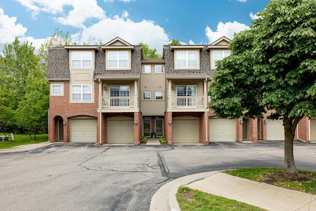 3039 Barclay Way, Ann Arbor, MI 48105 - townhome / multi-family property featuring roof with shingles, brick siding, mansard roof, and a garage