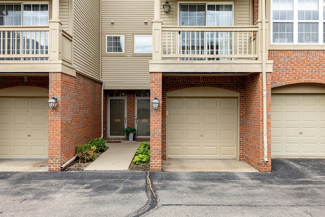 3039 Barclay Way, Ann Arbor, MI 48105 - property entrance featuring a balcony, brick siding, and an attached garage
