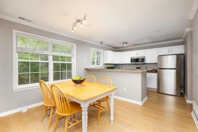 3039 Barclay Way, Ann Arbor, MI 48105 - dining room featuring light wood-style flooring, crown molding, and baseboards
