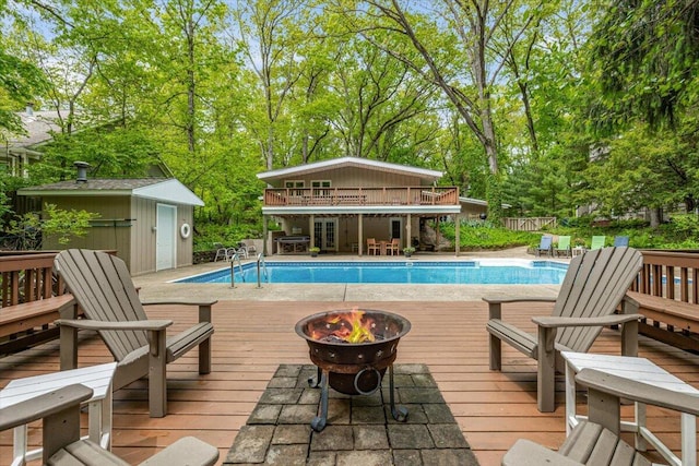14438 Spring Creek Dr, New Buffalo, MI 49117 - view of pool with a deck, an outdoor fire pit, grilling area, and view of scattered trees