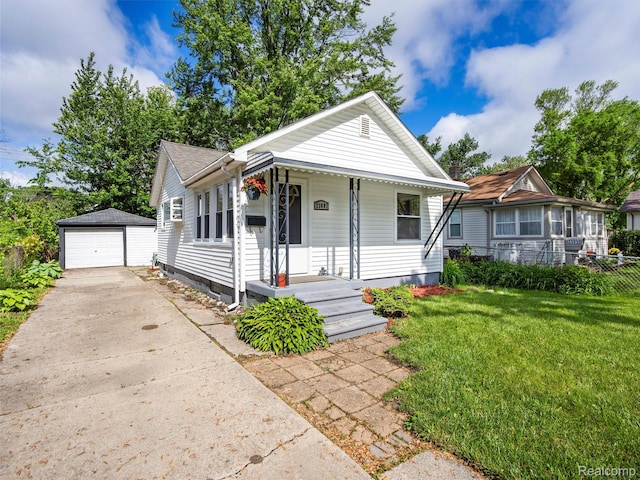 23091 Berdeno Ave, Hazel Park, MI 48030 - view of front of home featuring an outbuilding, concrete driveway, a detached garage, and covered porch