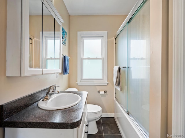 23091 Berdeno Ave, Hazel Park, MI 48030 - full bathroom featuring toilet, tile patterned flooring, vanity, enclosed tub / shower combo, and baseboards
