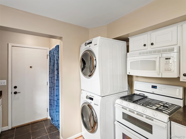 23091 Berdeno Ave, Hazel Park, MI 48030 - laundry room featuring estacked washer and dryer, dark tile patterned flooring, and baseboards