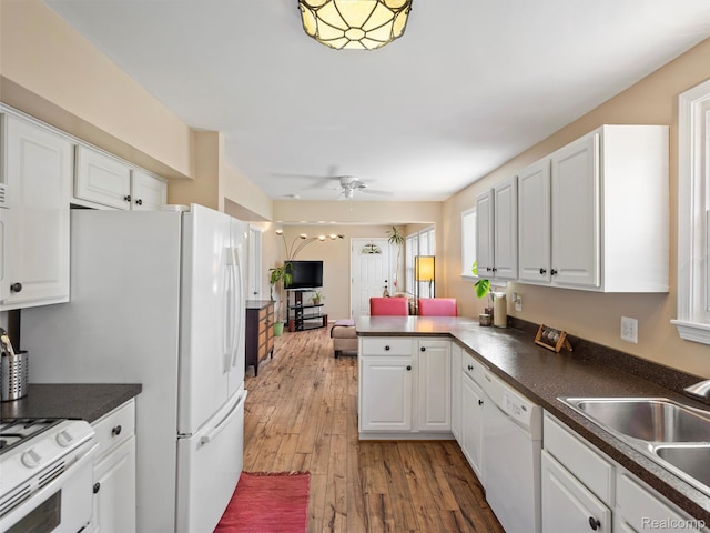23091 Berdeno Ave, Hazel Park, MI 48030 - kitchen featuring white appliances, white cabinetry, a sink, light wood-type flooring, and a peninsula