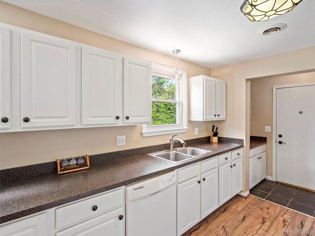 23091 Berdeno Ave, Hazel Park, MI 48030 - kitchen featuring white dishwasher, a sink, dark countertops, and white cabinetry