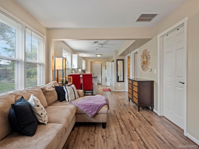 23091 Berdeno Ave, Hazel Park, MI 48030 - living area with light wood-style floors, a ceiling fan, and baseboards
