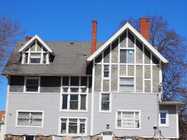 298 Capital Ave NE, Battle Creek, MI 49017 - rear view of property featuring a chimney