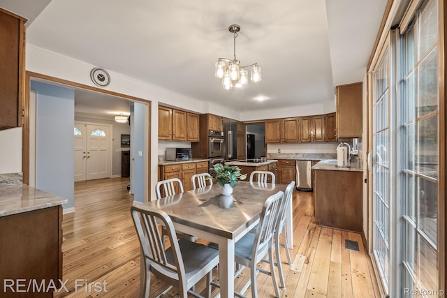 2983 Woodcreek Way, Bloomfield Hills, MI 48304 - dining area with a chandelier and light wood-style flooring