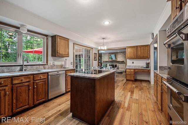 2983 Woodcreek Way, Bloomfield Hills, MI 48304 - kitchen featuring appliances with stainless steel finishes, a sink, light wood-type flooring, brown cabinetry, and recessed lighting