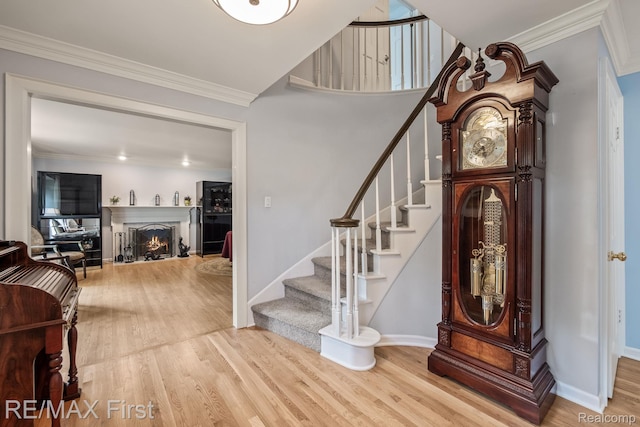 2983 Woodcreek Way, Bloomfield Hills, MI 48304 - stairs with wood finished floors, a lit fireplace, baseboards, and ornamental molding