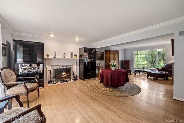 2983 Woodcreek Way, Bloomfield Hills, MI 48304 - living room with light wood-type flooring, a warm lit fireplace, crown molding, recessed lighting, and baseboards
