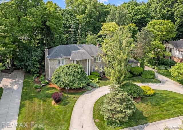 2983 Woodcreek Way, Bloomfield Hills, MI 48304 - view of front facade with a chimney, a front lawn, and brick siding