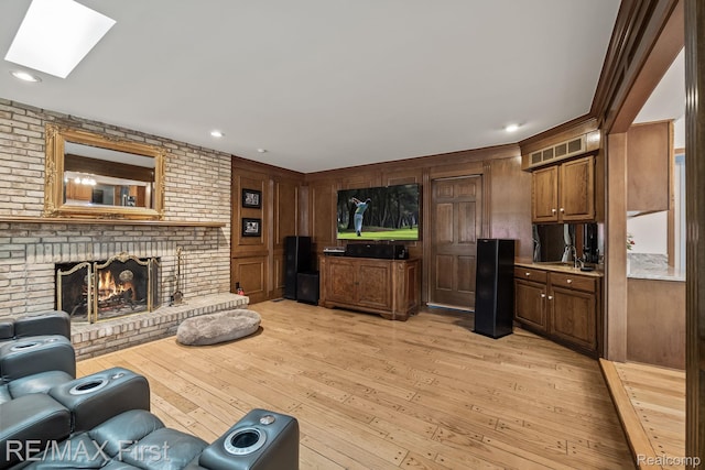 2983 Woodcreek Way, Bloomfield Hills, MI 48304 - living room with a skylight, light wood-type flooring, a fireplace, and recessed lighting