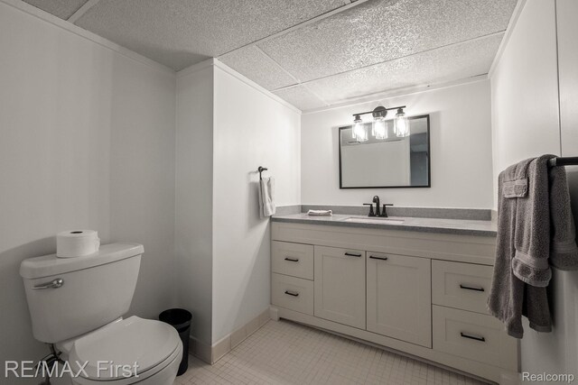 2983 Woodcreek Way, Bloomfield Hills, MI 48304 - half bathroom featuring vanity, toilet, tile patterned floors, and baseboards