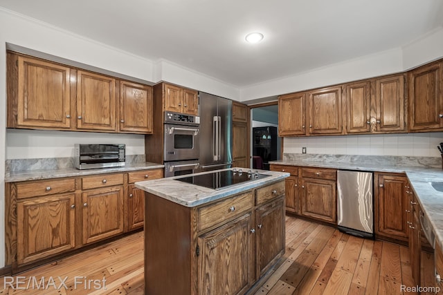 2983 Woodcreek Way, Bloomfield Hills, MI 48304 - kitchen featuring black electric stovetop, double oven, brown cabinetry, and crown molding