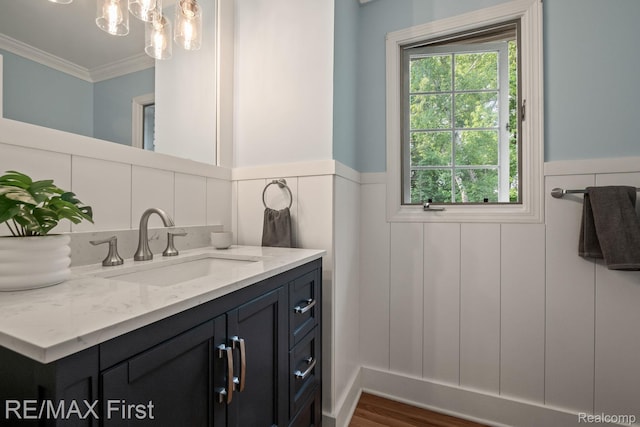 2983 Woodcreek Way, Bloomfield Hills, MI 48304 - bathroom featuring vanity, a wainscoted wall, crown molding, healthy amount of natural light, and a decorative wall