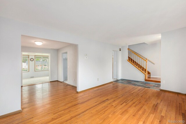 4772 Marian Ave, Warren, MI 48092 - unfurnished room featuring light wood-type flooring, stairs, and baseboards