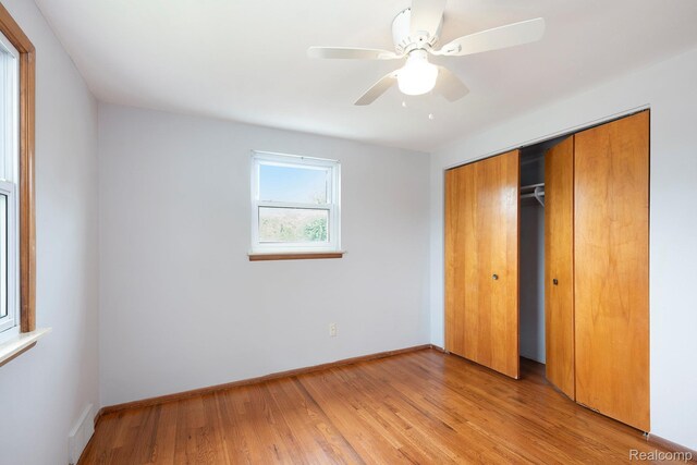 4772 Marian Ave, Warren, MI 48092 - unfurnished bedroom with light wood finished floors, baseboards, a closet, and a ceiling fan