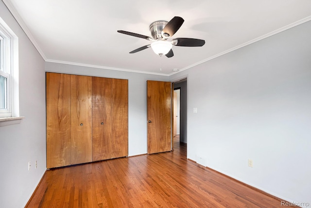 4772 Marian Ave, Warren, MI 48092 - unfurnished bedroom with wood finished floors, a closet, crown molding, baseboards, and a ceiling fan