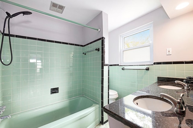 4772 Marian Ave, Warren, MI 48092 - bathroom with  shower combination, double vanity, tile walls, toilet, and a wainscoted wall