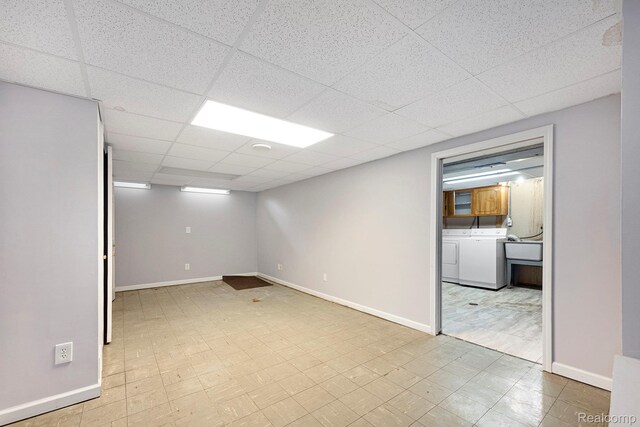 4772 Marian Ave, Warren, MI 48092 - finished below grade area featuring washer and clothes dryer, tile patterned floors, baseboards, and a drop ceiling