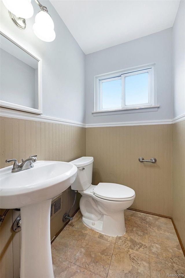 4772 Marian Ave, Warren, MI 48092 - bathroom featuring toilet, a wainscoted wall, and a sink